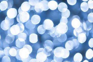 Wall Mural - soft blue bokeh background with shimmering light circles
