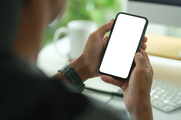 Wall Mural - close-up of a person holding a smartphone with a blank screen, ideal for showcasing mobile app desig