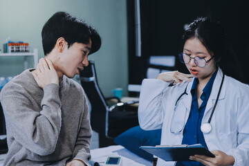 Wall Mural - Female physician reads medical history while visiting her patient