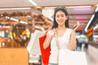 © dodotone - People city lifestyles with buying shopping consumerism. Young adult asian woman happy smile face standing at indoors department store on day. Price sale discount season.