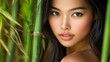 © liliyabatyrova - A young asian model with radiant skin and flowing hair stands amidst vibrant bamboo. She captures a tranquil moment, exuding beauty and grace in a natural environment