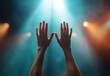 © DWN Media - Hands Raised in Celebration Under Stage Lights