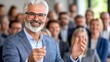 © Biggy - Smiling Mature Man Engaging Audience at Corporate Event Conference