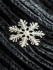 Poster - Close-up view of a delicate snowflake resting on a dark woolen glove during winter