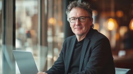 Aufkleber - Relaxed professional working in a modern workspace with a laptop during the day