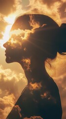 Leinwandbilder - Woman's silhouette radiates warmth and light against a backdrop of golden clouds at sunset capturing serenity and beauty