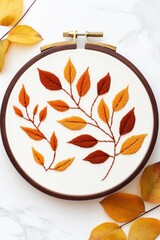 Poster - Handmade crewel embroidery wall art featuring intricate nature-inspired leaf patterns in soft warm lighting