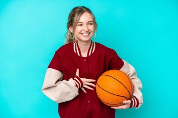 young basketball player caucasian woman isolated on blue background smiling a lot