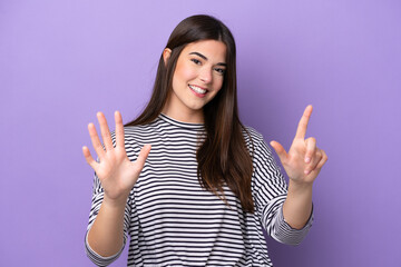 Wall Mural - Young Brazilian woman isolated on purple background counting seven with fingers