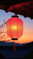 Wall Mural - A glowing red lantern hangs against a colorful sunset, creating a serene atmosphere.