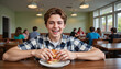 © Iryna - Excited 14-year-old white boy laughing while holding a sandwich at school cafeteria