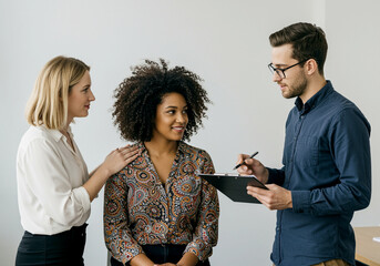 Wall Mural - People in business meeting with team collaboration. Woman consoling another woman during business meeting. Business people working together