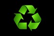 © haiqiang - a close up of a green recycle logo on a black background