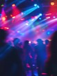 © Johannes - Blurred people inside disco club with colorful laser lights in background - Defocused image - Concept of nightlife with music entertainment - Original color bokeh - Warm vivid filter