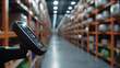 © Maksym - A smart inventory tracking device and barcode scanner are in focus in the foreground, with rows of organized, blurred shelves in the background, emphasizing the blend of human and