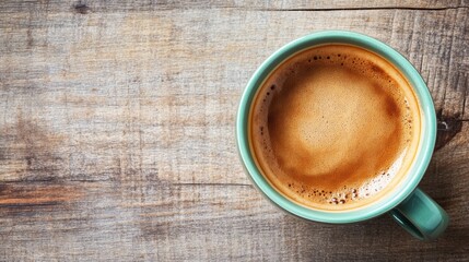 Wall Mural - Cup of fresh espresso coffee in green mug on rustic wooden table