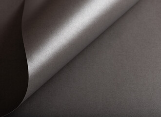 Poster - Charcoal gray paper background with a pearlescent, glossy texture and shimmering wavy edges. Deep graphite and gunmetal tones create a sleek, elegant, and luxurious abstract design.