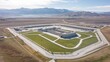 © Murda - Large complex building airport mountain landscape drone view