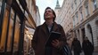 © Spring Melody - Smiling man walks through a historic street in a European city while holding a tablet on a chilly afternoon