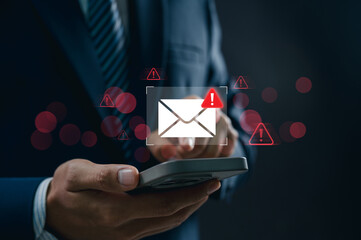 Fototapete - Concept of spam email alert and cyber attack danger. Businessman using smartphone receiving email warning alert, phishing scam notification displayed on mobile screen.