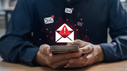 Fototapete - Phishing scam and spam email warning concept. office worker checks mobile phone, symbolizing cybersecurity attack threat, alert message and digital safety challenge