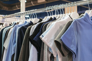 Aufkleber - A rack of clothes with a blue shirt hanging from the top. The clothes are hanging on a rack and are of different colors