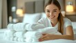 © MABRUR - Woman smiling, hotel room, clean towels, bed, happy