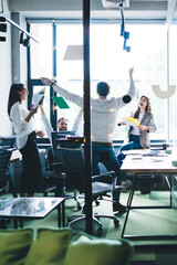 Wall Mural - Happy coworkers celebrating success in office