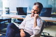 © BullRun - Merry employee smiling during phone conversation