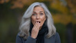 © Kate - A woman with long gray hair is looking surprised