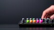 © danadesa - Hand adjusting audio mixer; dark background; music production