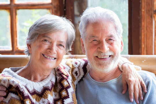 Portrait of elderly happy couple in indoor at home, mountain chalet, smiling and having fun together. Happiness and serene old lifestyle people enjoying vacation