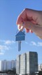 © Anastasiya - Holding house keys on house shaped keychain concept for buying a new home. Vertical - the key to the house is in the hands of the agent. The concept of building a new house.
