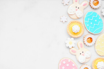 Aufkleber - Easter or spring themed baking side border with assorted cookies and sweet desserts. Overhead view on a white marble background with copy space.