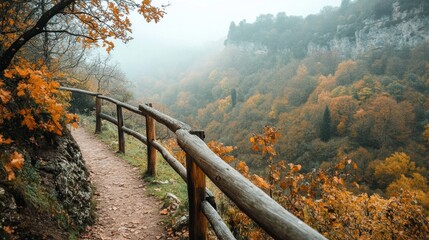 Sticker - Foggy autumn hiking path with a wooden railing overlooking valley