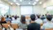 © LU - Corporate Seminar Blur: A blurred background of a corporate seminar or training session in a conference hall, with attendees.