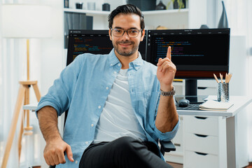 profile's smart it developer looking camera to pose wearing glasses against on software development 