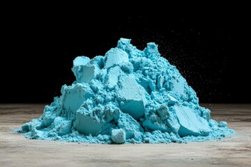 Wall Mural - a burst of blue powder against a black backdrop, creating a vibrant, colorful cloud
