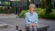 © Yuliia - Mature woman working outside old business lady in eyeglasses hold laptop pc smiling senior businesswoman in city modern urban street downtown female entrepreneur work outdoors dream think looking away