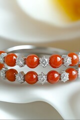 Poster - Elegant pair of stylish orange gemstone bracelets adorned with sparkling diamonds and placed on a soft background : Generative AI