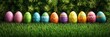 © Margarita Ratatosk - Colorful decorated Easter eggs in row on green grass with natural sunlight. Traditional holiday celebration design concept for spring greeting card