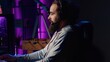 © DC Studio - Close up shot of man chatting with teammates online while playing video games on gaming PC, relaxing after work. Gamer battling enemies in online multiplayer shooter, talking through headphones mic