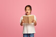 © Prostock-studio - Focused diverse schoolkids reading books on pink background