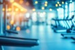 © gankevstock - Blurred bright and modern gym interior with illuminated workout equipment