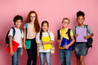 © Prostock-studio - Multiethnic group of kids ready for school with backpacks and copybooks over pink background