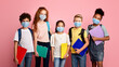 © Prostock-studio - Health care and education concept. Portrait of schoolchildren wearing protective masks against pink background