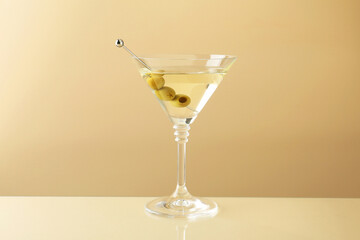 Wall Mural - Martini cocktail with olives in glass on beige table