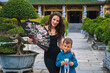 © alexkoral - family of tourists mom and son at Buddhist temple at Linh Ung Pagoda in Da Nang in Vietnam. Concept of travel and tourism in Asia