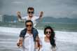 © alexkoral - happy young family with a child son on the beach by the sea in summer on vacation