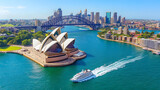 A large cruise ship is sailing through the water near a city